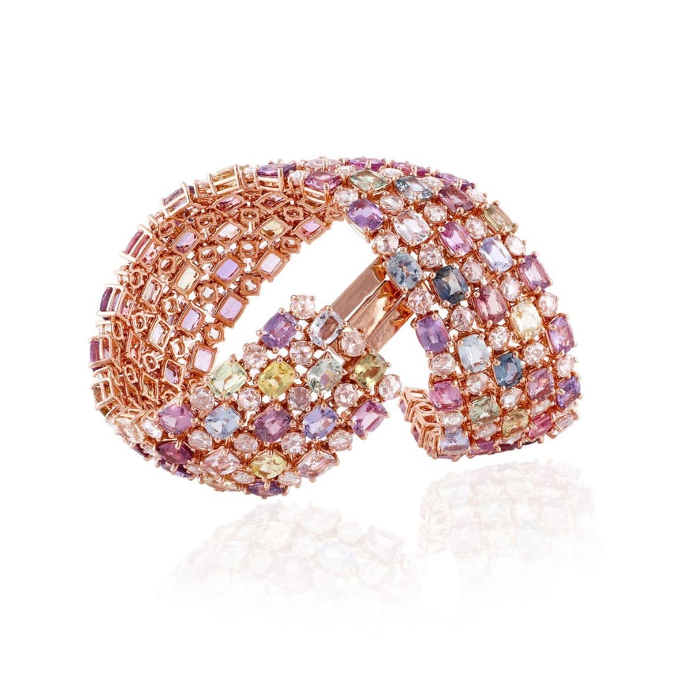Wide open rose gold cuff densely set with pastel cushion and rose-cut sapphires