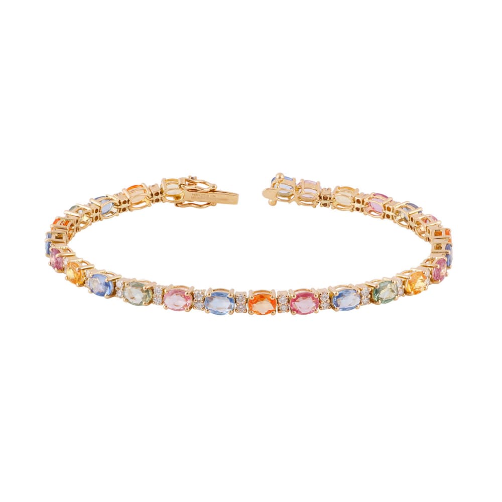 Pulsera de oro amarillo con zafiros de color ovalados dispuestos en travesía y separados por diamantes redondos