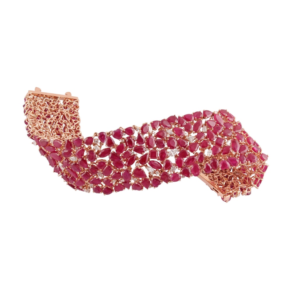 Wide rose gold bracelet massed with mixed-cut rubies and scattered round diamonds