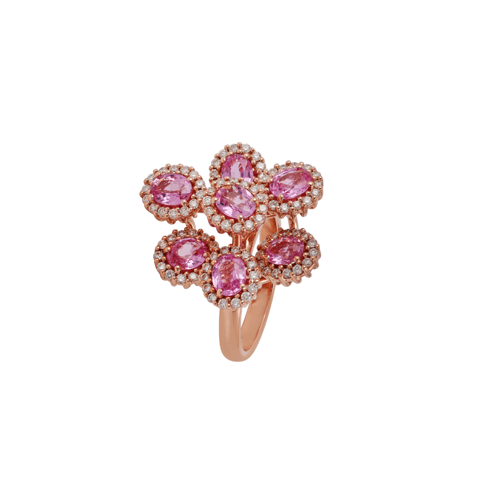 Rose gold ring with two overlapping clusters of oval pink sapphires in diamond halos