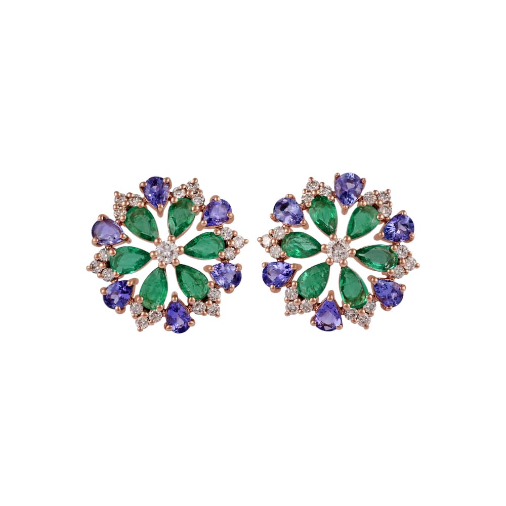 Rose gold pinwheel earrings of pear emeralds around a diamond centre with tanzanite behind