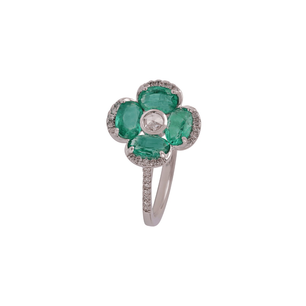 White gold flower ring with four oval emerald petals and a rose-cut diamond centre