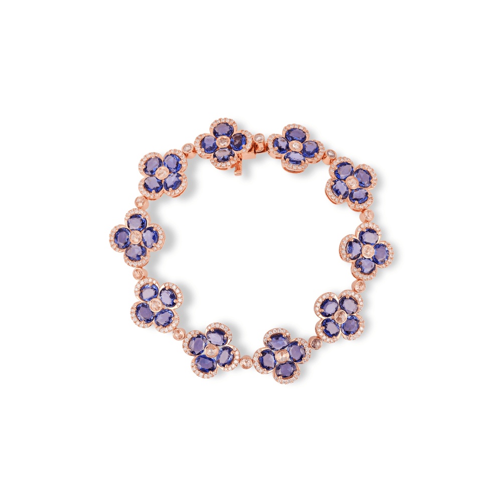 Rose gold bracelet of nine four-petal blue sapphire flowers outlined in diamonds