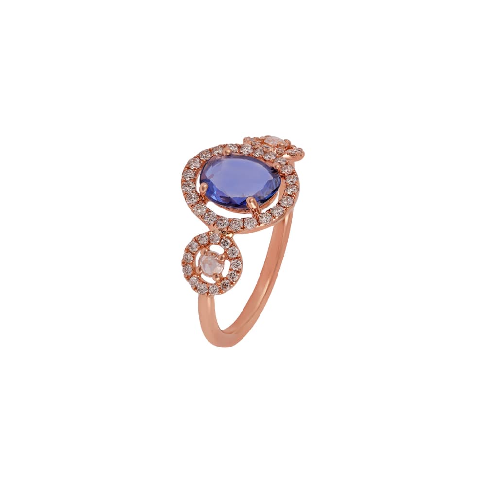 Anillo de oro rosa con una tanzanita ovalada en halo de diamantes sobre una piedra menor también con halo