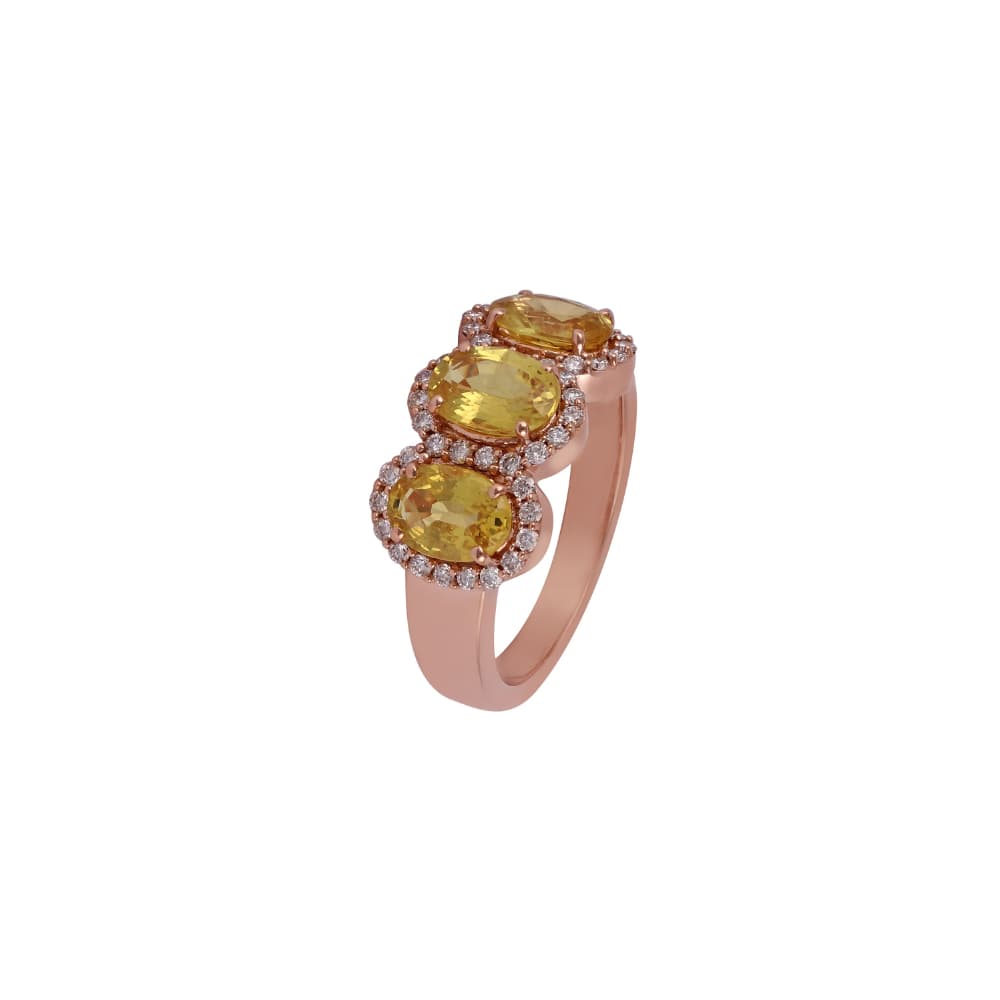 Rose gold ring with three oval yellow sapphires set diagonally in touching diamond haloes