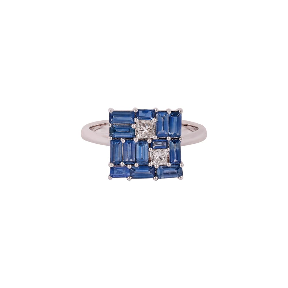 White gold ring with a square panel of blue sapphire baguettes and two princess-cut diamonds